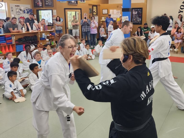 Adult Taekwondo student breaking a board